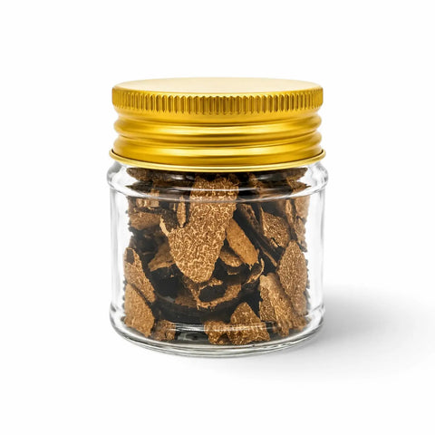 Dried Tuber aestivum summer truffle slices in a clear glass jar with a yellow lid