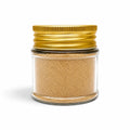 Morel powder (Morchella esculenta) in a clear glass jar with a gold lid