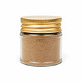 Spring white truffle powder (Tuber borchii) in a clear glass jar with a yellow lid