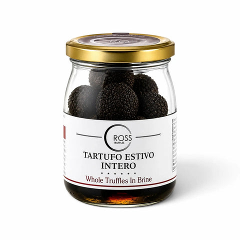 Whole Tuber aestivum summer truffles preserved in brine in a glass jar